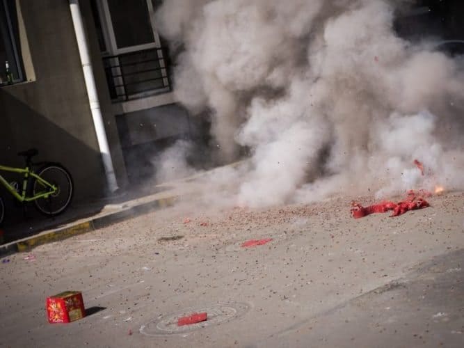 The firecrackers exploding in a plume of smoke. Photo by James Pope.