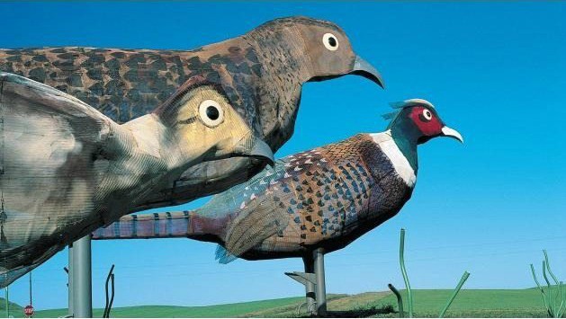 'Pheasants on the Prairie' has four pheasants: a 40-foot tall rooster, a 35-foot tall hen and two chicks that reach 15 feet high. Together the fowl family weighs a massive 30,000 pounds. These are on the Enchanted Highway in North Dakota.