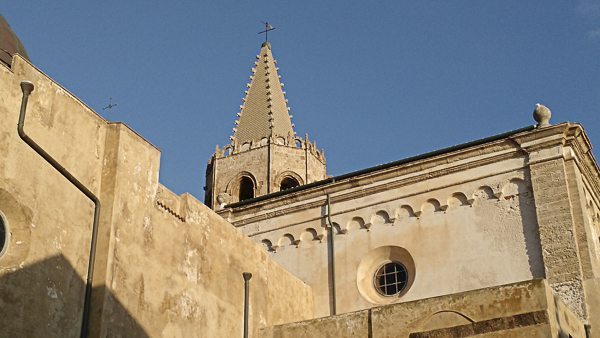 A church steeple against blue sky in Cagliari, Sardinia.