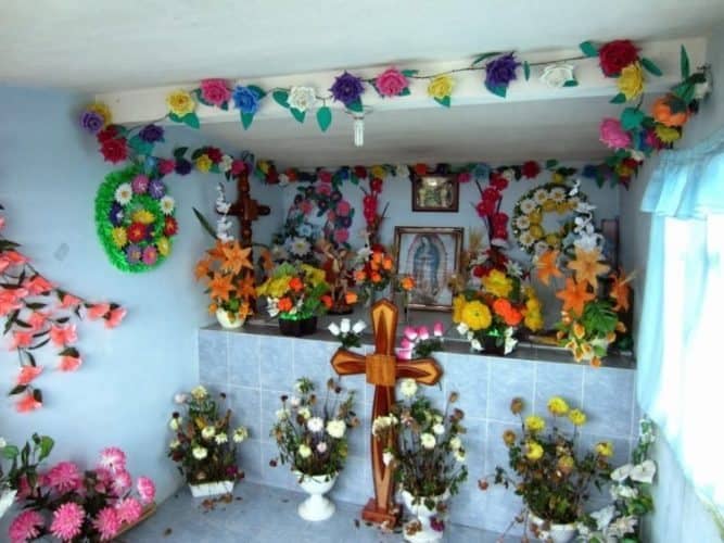 Colorful flowers decorate a religious spot in the area. 