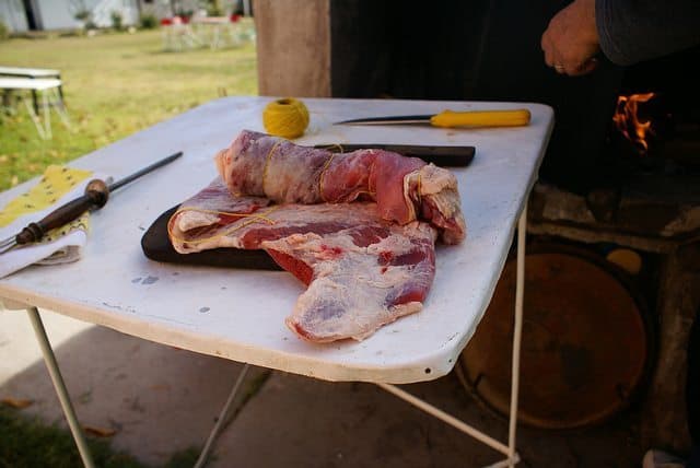 Argentina: Mendoza, Sun and Good Wine 5 Meat is King. Preparing a huge slab of beef for the coals.