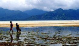 Two young girls walking out across the shallows at low tide on the Indonesian island of Gili Air. Michael Molyneaux photos.