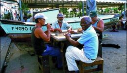 Men in San Antonio de los Baňos play the Cuban version of dominoes. Talking during the game is both allowed and encouraged by the players and the people watching the game.
