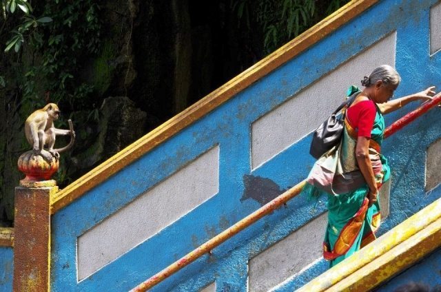 A Hindu penitent walking up the 272 concrete steps to the shrine at Batu Caves, outside of Kuala Lumpur, Malaysia.