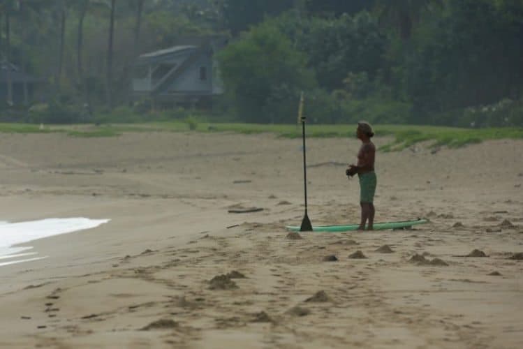 Titus Kinimaka surveys the surf from the beach at Hanalei Bay Kauai HI. Photo by Ry Cowan