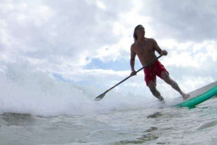Titus Kinimaka in command of his stand up paddle at Hanalei Bay Kauai HI. Photo by Ry Cowan