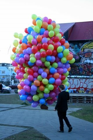 Man walks his cat in a basket of balloons in Reykjavik and no one bats an eye.