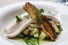 Ateljee Finne restaurant, Helsinki. Oven poached white fish with potato cucumber salad and cucumber vinaigrette. 
