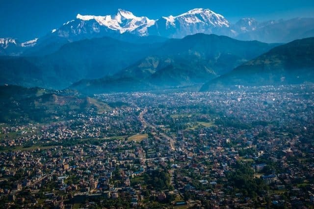 The city of Pokhara is dwarfed by the snow-capped Annapurna Mountains.