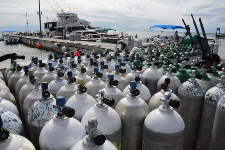 SCUBA tanks at Amigos Del Mar Dive Shop await journeys to the Great Blue Hole.