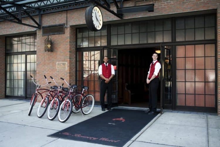 The Bowery Hotel front door men and bikes for guests to borrow.