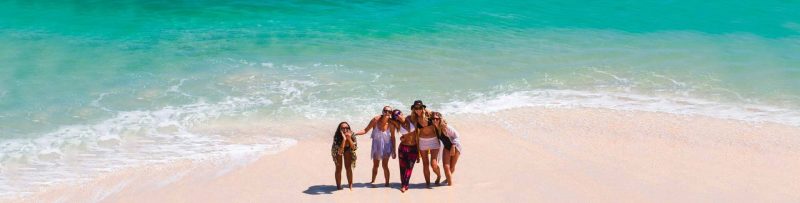 Women playing in the pristine beaches near Ocean Soul.