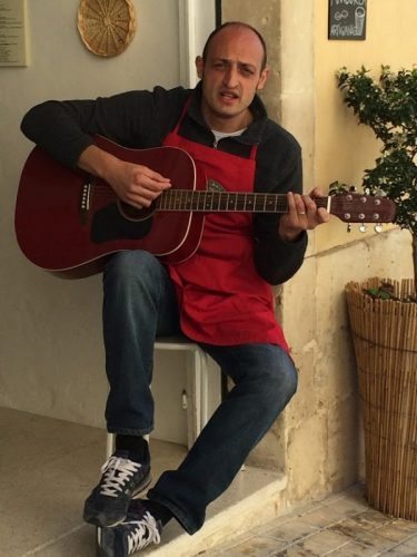 Singer outside a gelateria in Noto. John Henderson photo.