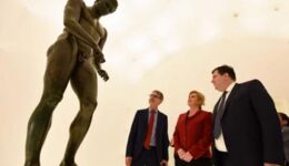 The president of Croatia, Kolina Grabar Kitarović, center, admires Apoxyomenos in his new home.