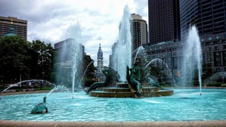 in the middle of Benjamin Franklin Boulevard is Logan Fountain with the statue of William Penn atop City Hall in the distance. Philadelphia