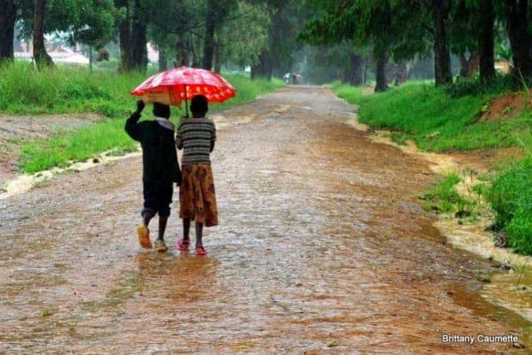 Children wading through the puddles on their way to Livingstonia town.