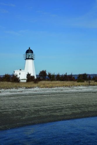 Sandy Point lighthouse and shore. The quality of the beach likely influenced the name of the jutting piece of land.