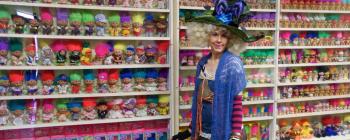 Sigrid, the "Troll Queen," in front of a collection troll dolls in Ohio