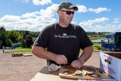 shucking oysters at raspberry point oyster co