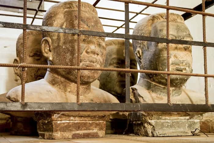 Busts of Pol Pot are now ironically caged. Paul Pot was the leader of the Khmer Rouge who died in 1997.