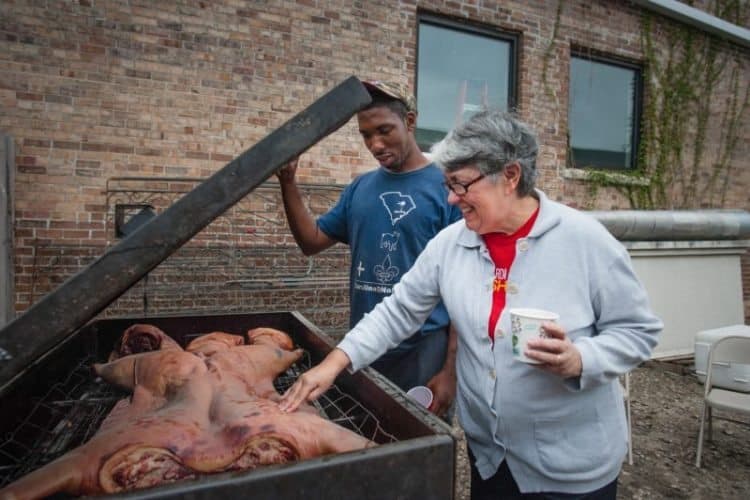 Director Liz Williams testing the South Carolinian whole-hog barbecue made by SoFAB Fellow Dr. Howard Conyers 