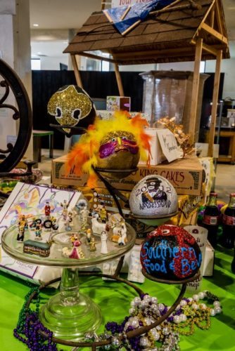 Closeup of the Mardi Gras section in the Louisiana exhibit--showing coconuts handprinted by Zulu, King Cake boxes, and a collection of handmade porcelain King Cake fevres.