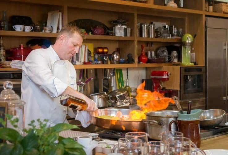 Chef Tory McPhail of Commanders Palace in the Rouses Culinary Innovation Center by Jenn-Air, demonstrating one of his dishes.