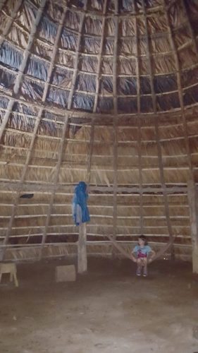 The scale of the conical thatched huts is seen here. 