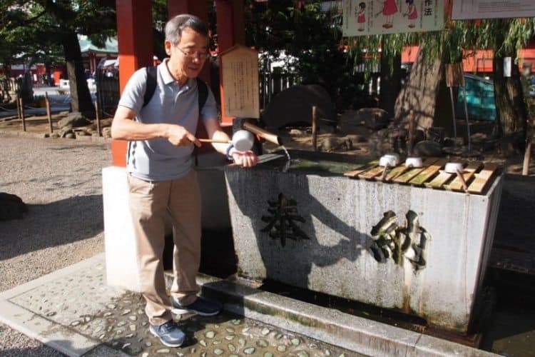 The ritual of handwashing with a special ladle is demonstrated at the Senso-Ji Temple at the Asakusa Shrine in Tokyo.
