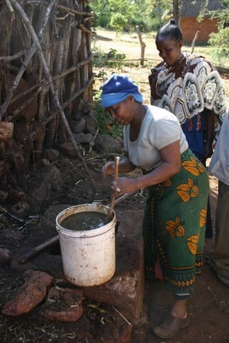 Tanzania Mixing up food for dinner in the village.