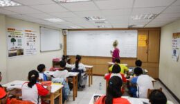 The author teaching English in a classroom in Taiwan. The real money, though, is in private tutoring, she says.