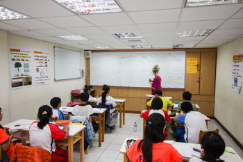 The author teaching English in a classroom in Taiwan. The real money, though, is in private tutoring, she says.