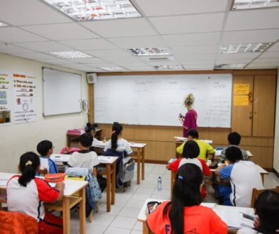 The author teaching English in a classroom in Taiwan. The real money, though, is in private tutoring, she says.