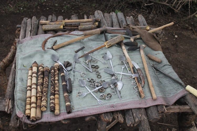 The tools used to create the blacksmith's creations laid out on the ground.