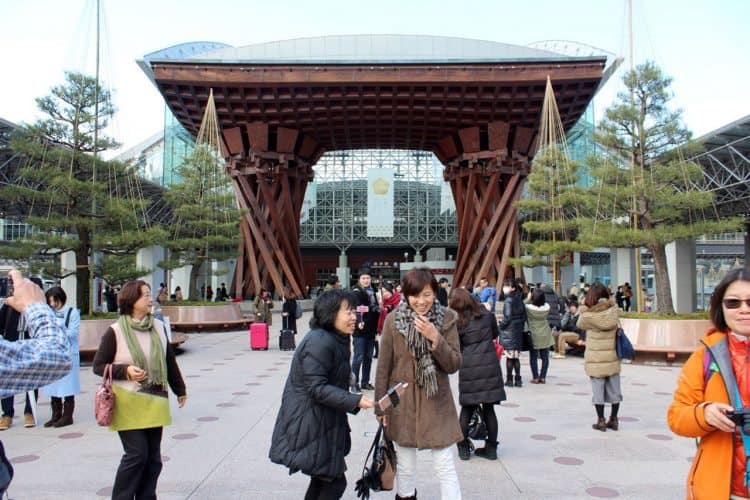 Tourists at Kanazawa station taking selfies