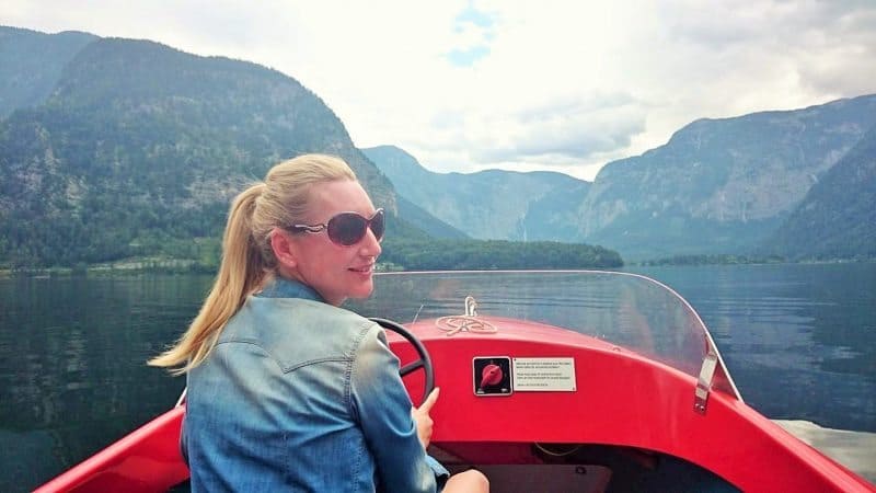 Red electric boat ride on Hallstatt Lake, Austria.