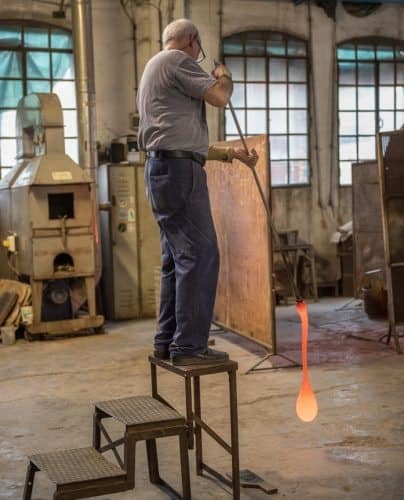 Glassblowing requires both strength and stamina, especially with larger pieces, as seen here with this artisan.