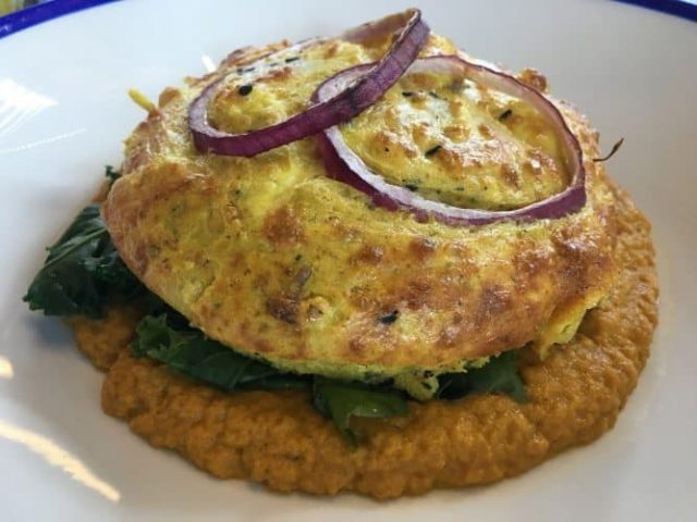 A cauliflower, cheddar and stilton bake atop carrot hummous and buttered kale from the Westcorner, a great lunch spot in the Northern Quarter.