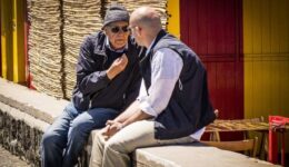Men in Italy love to spend time chatting in the sun.