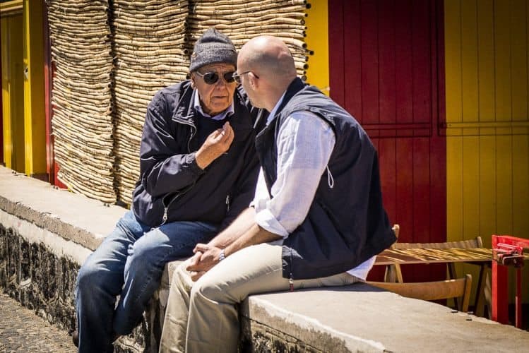 Men in Italy love to spend time chatting in the sun.