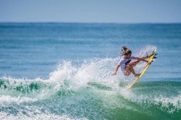 A surfer rides a wave in Santa Teresa