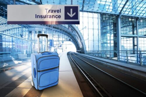 Travel Insurance. Blue suitcase at the railway station