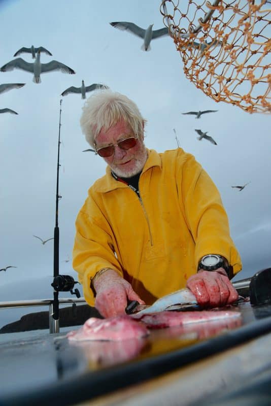 Captain Charlie can gut and clean a pail full of North Coast fish in less time than it takes for the skipper to return to shore.