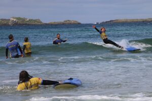 The author of this story survives several wipe-outs before retiring to the beach. Photo by Billy Scott.