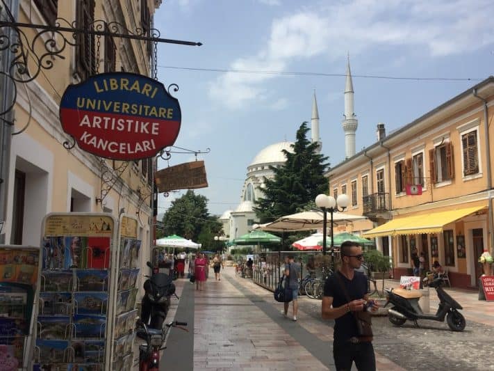 Kolë Idromeno Street, the main pedestrian drag, in Shkodër, with Ebu Bekr Mosque in the background.