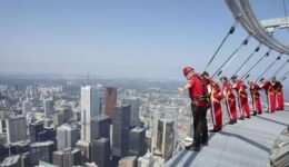 CN-Tower Toronto: if you are daring enough, you can hang off the edge like these guys are doing!