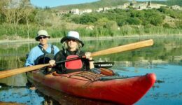 The author and her husband Peter Petre on Lake Trasimeno. In the background is the village of San Savino, inhabited since the Etruscan period. Photo by Allison Thiel.