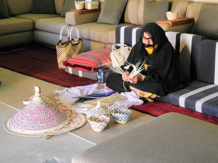 Traditional palm weaving by Bedouin woman wearing modesty mask, Al Ain Fort Jahili. | GoNOMAD Travel