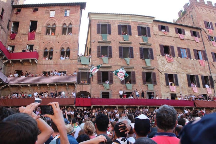 Flying flags follow their trajectory after being thrown from unseen hands. 