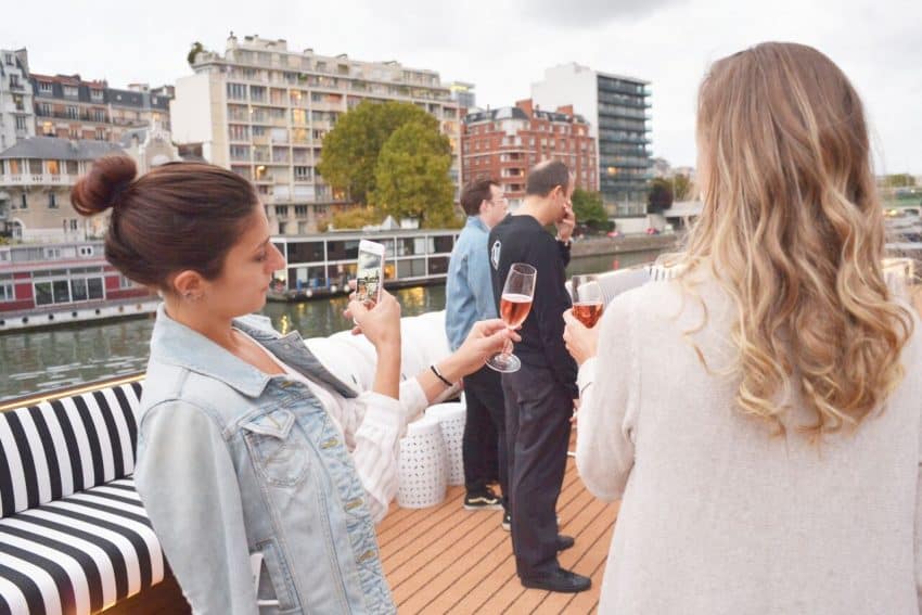 U by Uniworld cruisegoer takes a photograph of her drink.